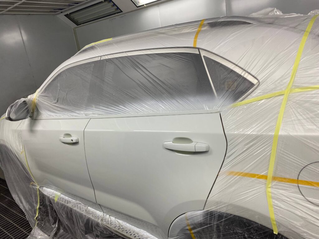 Professional body shop applying eco-friendly masking film to car body for automotive refinishing by Cheerlyh(Songcheng)